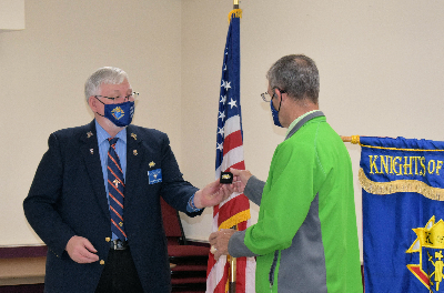 Past Grand Knight Eddie Williams awards Dept. Grand Knight Rick Khors the pin for his role as in Council 6451 achieving the 2019 Star Council Award.